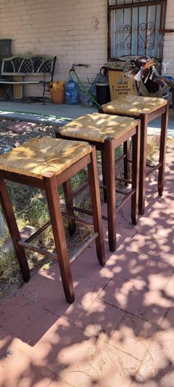 SET OF 3 Brown straw seat stools. 48 Inc high in good condition.
