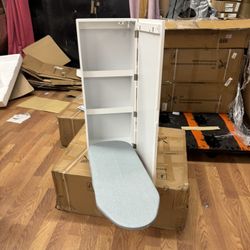 White wall mounted ironing board with mirror and adjustable board. 14”W x 8”D x 37.5”H 