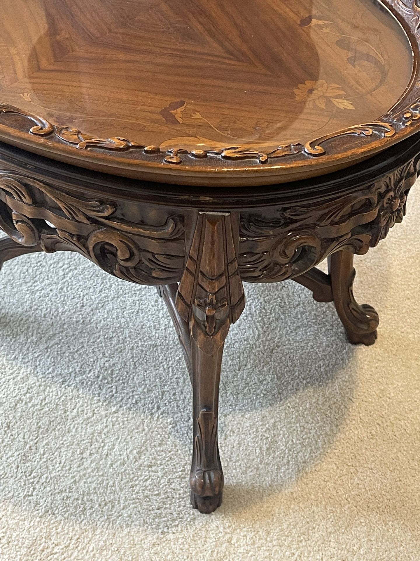 Ornate carved wood table with framed glass top serving tray