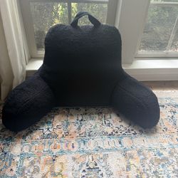 Black fleece “husband” or bed rest style pillow