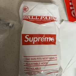 Supreme Ballpark Rain Poncho in white and red. 