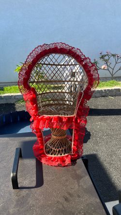 Arching, patch, miniature wicker chair with red ribbon and pearls