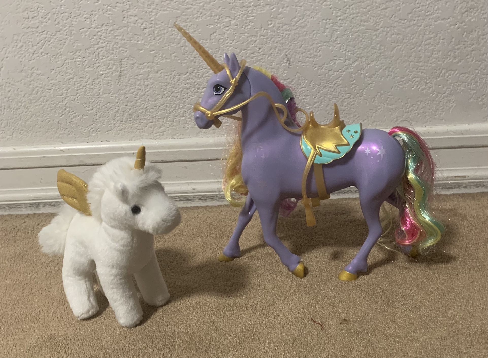 2 Unicorns. One Plush And the other Interactive Toy
