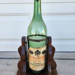 Empty Courvoisier Cognac Vintage Large Green Bottle on Wood Stand