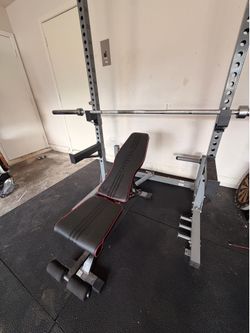 Squat rack w/ barbell + 255lbs