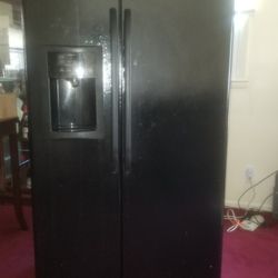 Black Side By Side Refrigerator 35 1/2" wide, 30 1/2" deep, 68 1/2 height. Ice tray cover broken but still works, water dispenser works, needs filter