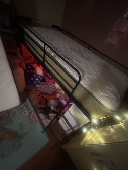 Twin bed frame with mattress and new sheets