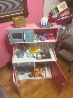 Wooden Kitchen set with food and dishes.
