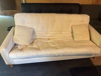 White Futon Sofa Bed with matching pillows