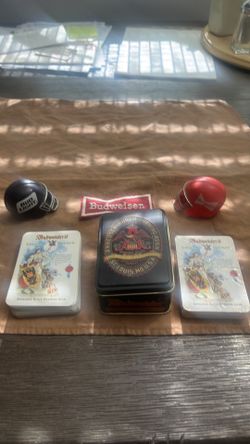 Pair of bud bowl helmets, a two pack deck of Anheuser Busch cards, and Budweiser patch