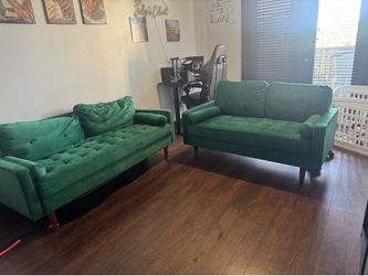 Two green suede couches
