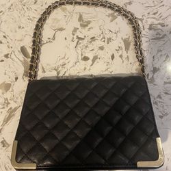 Black leather handbag with gold chain