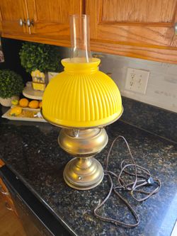 Vintage kerosene lamp with yellow glass shade