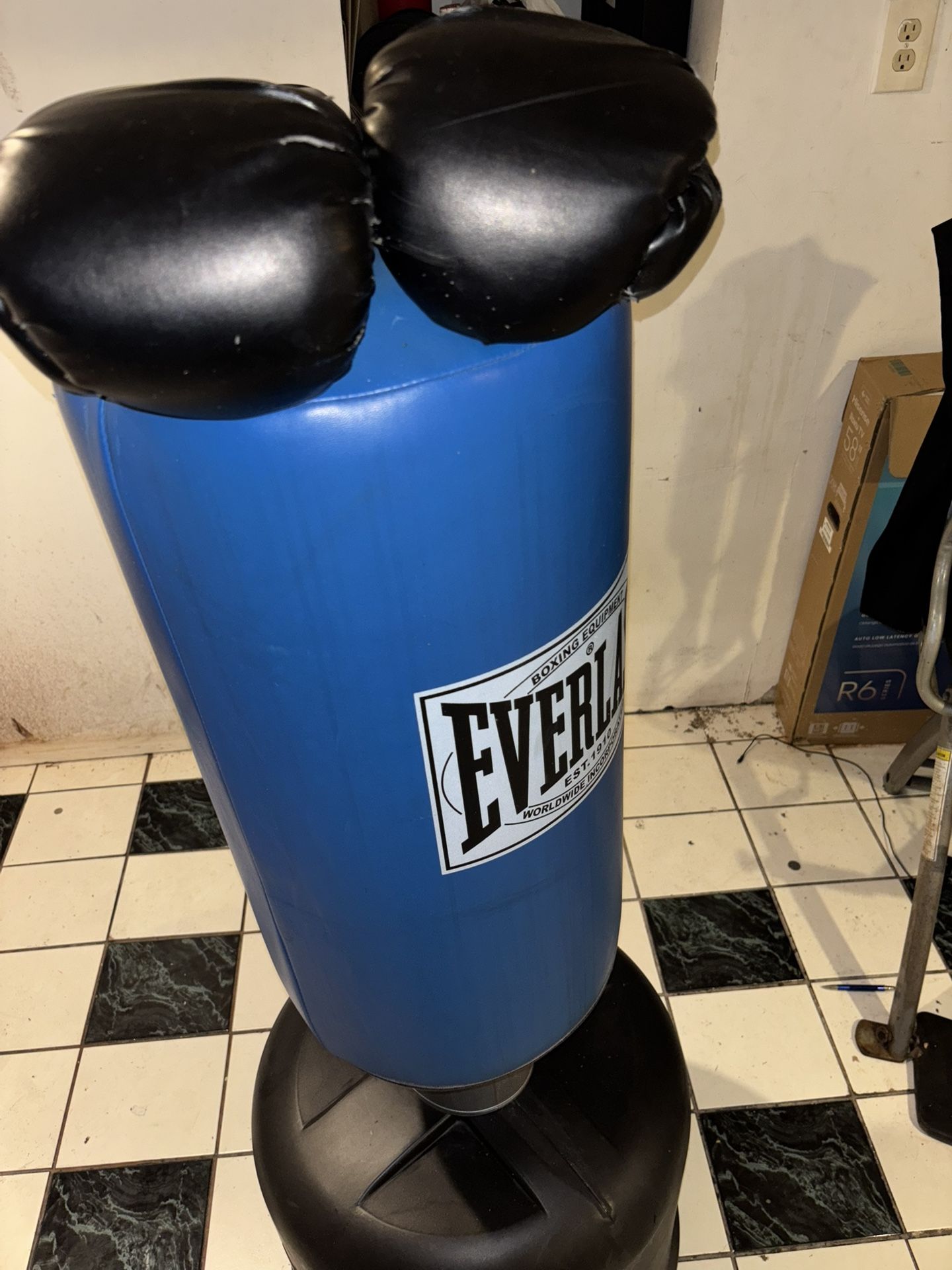 Blue Everlast punching bag with gloves.