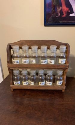 Spice rack in wood container that can be hung on wall.