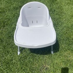 high chair with a tray.
