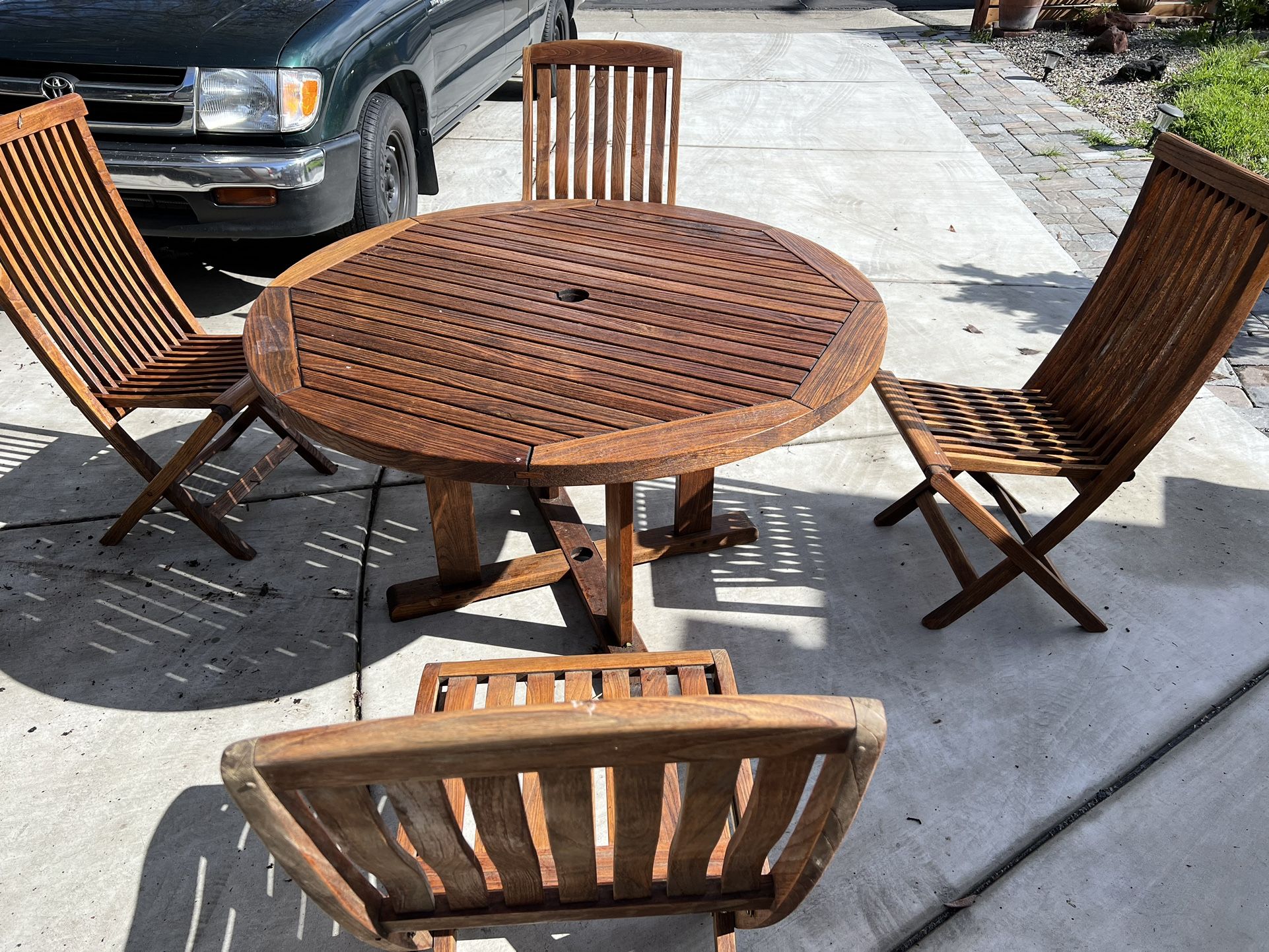 smith and hawken round teak table and 4 foldable teak chairs