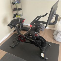 Peloton Bike + Kit Including Yoga Mat And Blocks, And Two Pairs Of Shoes