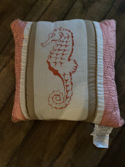 Decorative throw pillow with seahorse.