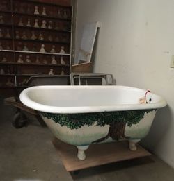 Antique white porcelain enamel tub with the exterior having been painted by a famous Scottish artist, George Kieth-Beattie