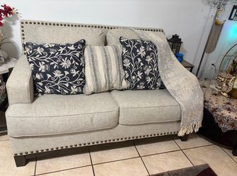 2 pieces 1 Beige Fabric Loveseat  and 1 three seater sofa with Nailhead Trim