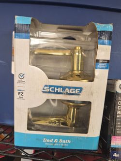 Schlage Flair Bed & Bath door lever in a bright brass finish.