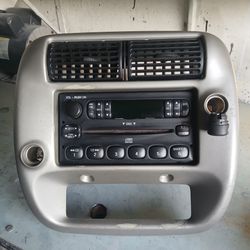OEM factory AM/FM/CD radio and center bezel assembly from a 2001–2005 Ford Ranger