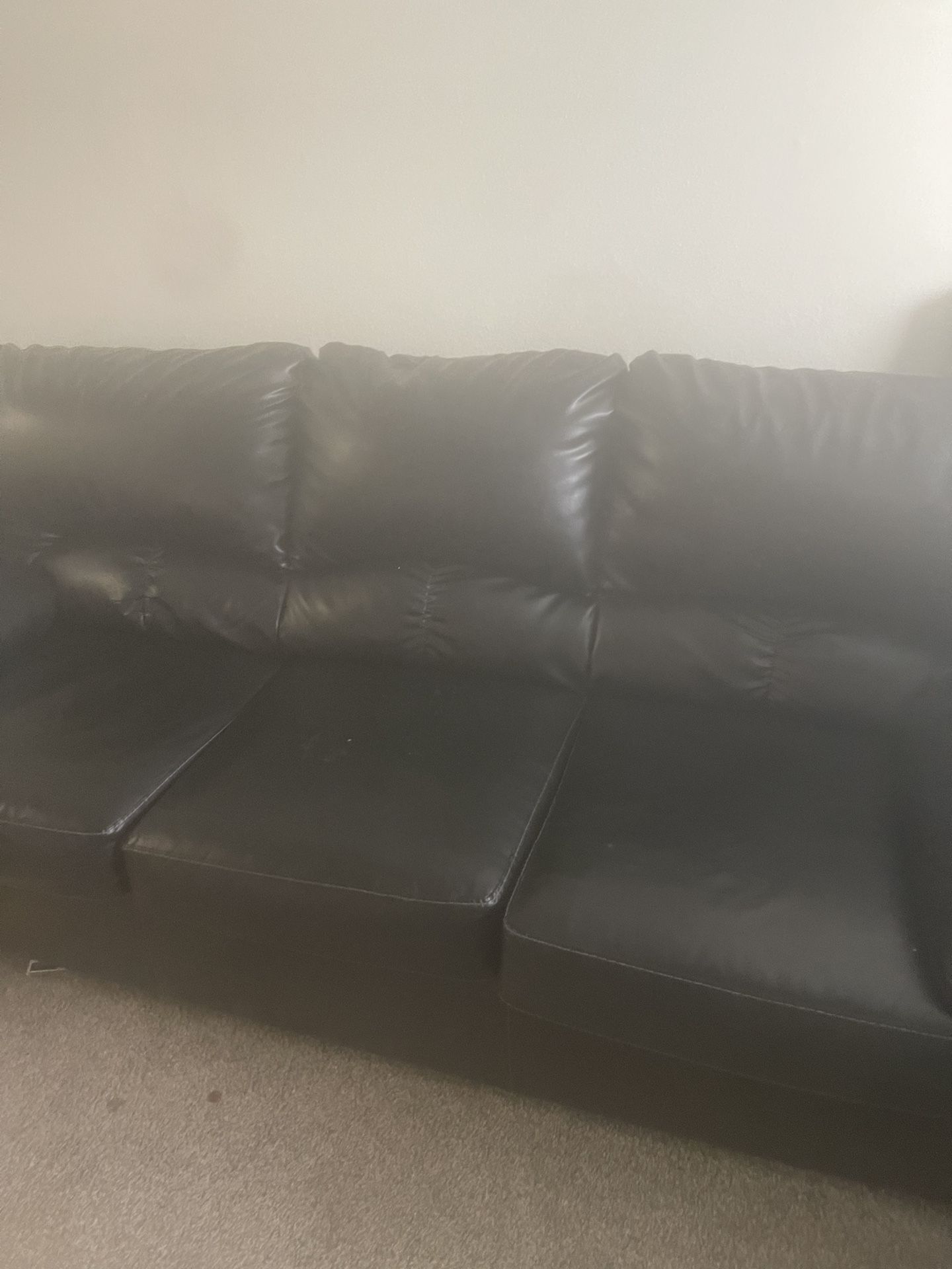 Black leather couches, loveseat, and sofa