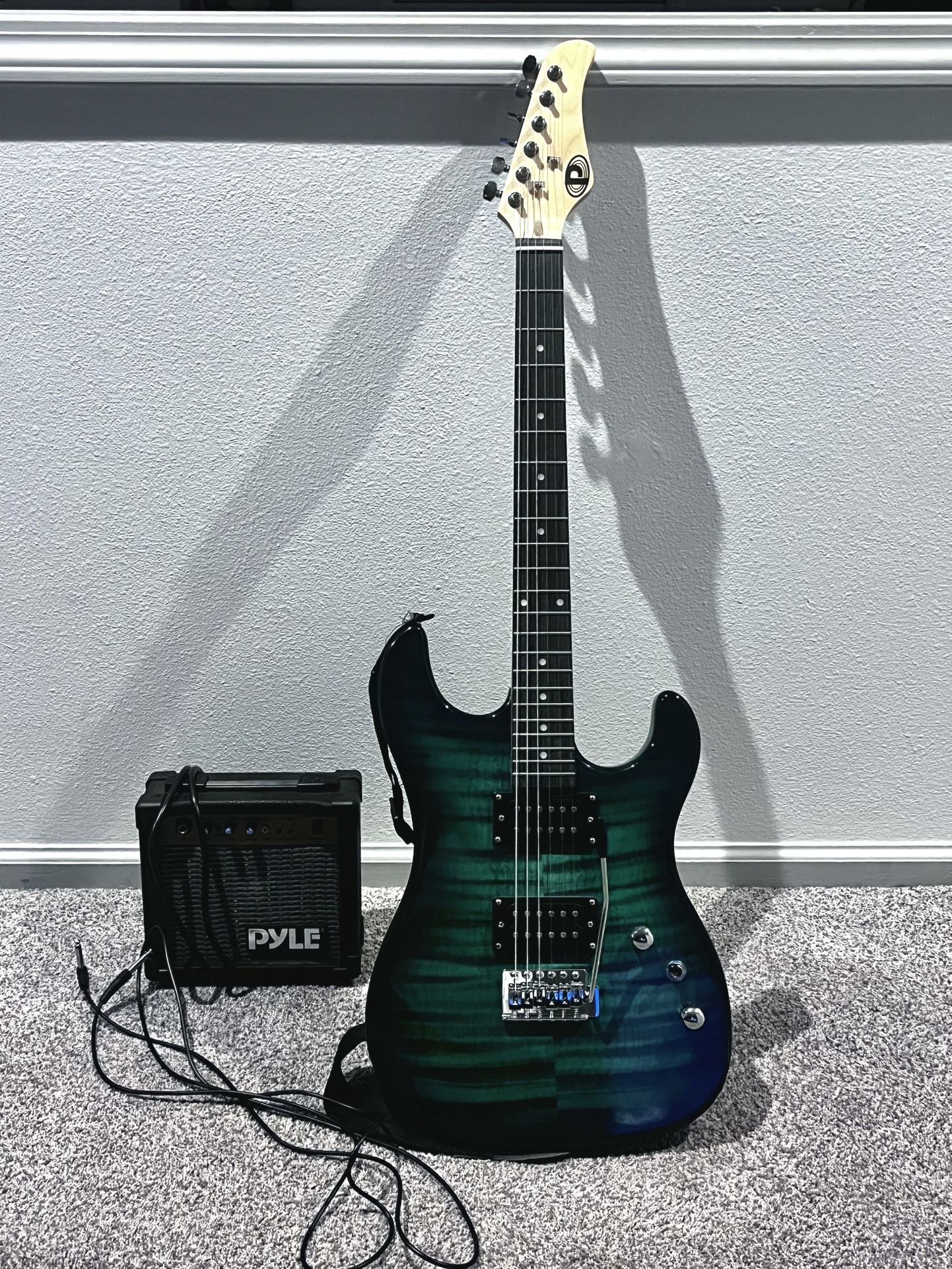 Electric Guitar With Cord And Small Amp