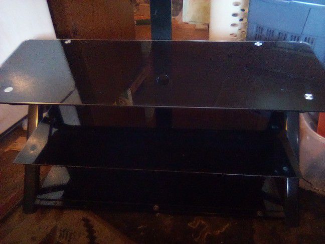 Black Glass Entertainment System With Three Shelves An Amount On Top For Flat Screen TVs