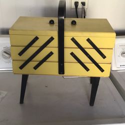 Wooden storage container with sewing supplies