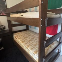 Bunk bed 2x6 bolted wood very solid , very sturdy,   it comes with mattress.