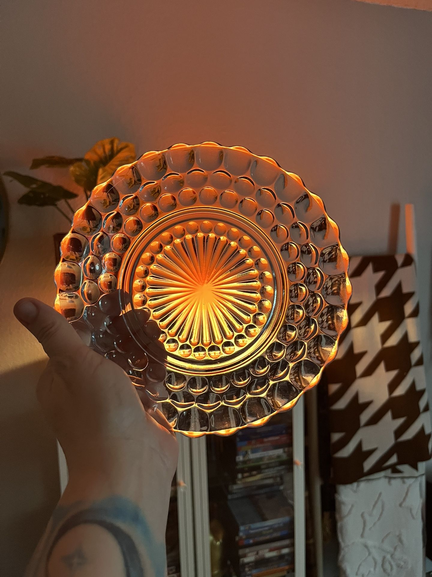 This is a pale blue pressed glass plate in the bubble pattern by Anchor Hocking
