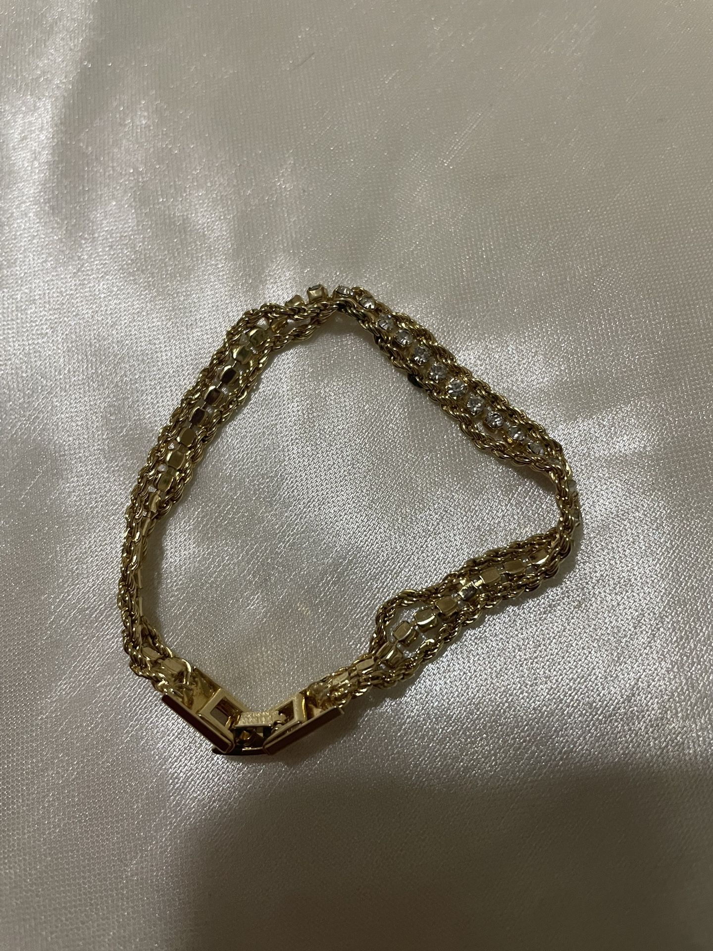 1960’s gold-tone braided chain bracelet with a center row of rhinestones