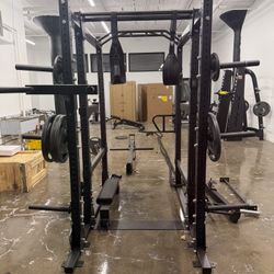 Power rack or squat cage, often a multi-functional model with various attachments
