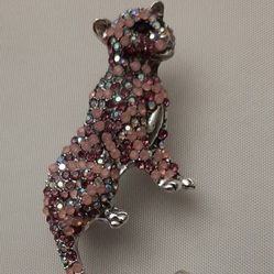 Decorative Panther brooch with pink rhinestones.