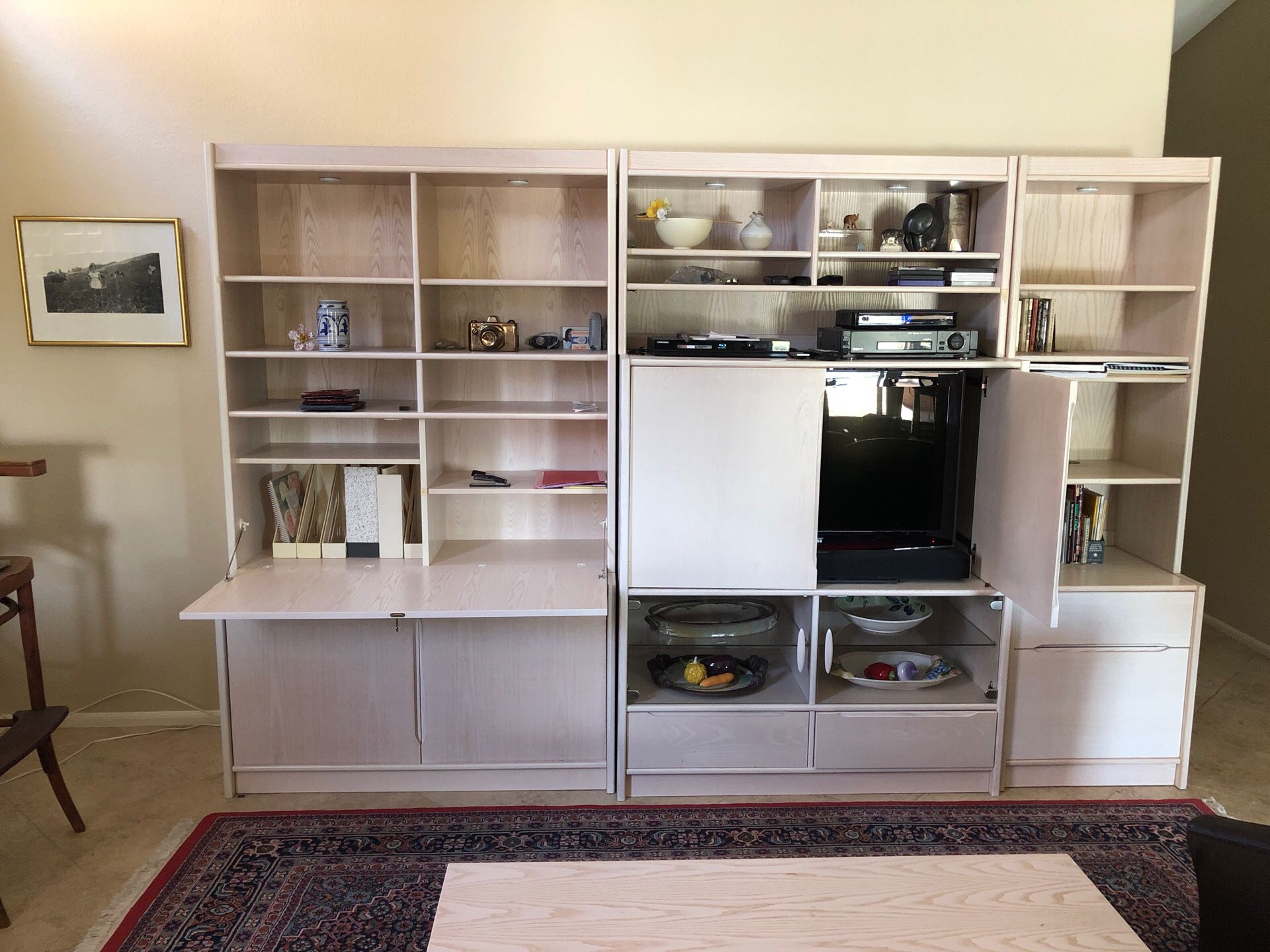 Entertainment unit with desk, file cabinet, book case, shelves, drawers.