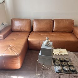 Brown  Leather sectional 2 piece sofa with ottoman.