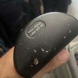 Epperson golf putter in right hand  Steel shaft  