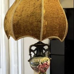 Selling a vintage Capodimonte porcelain table lamp. It features hand-painted scenes with figures and intricate porcelain work. This lamp originates fr