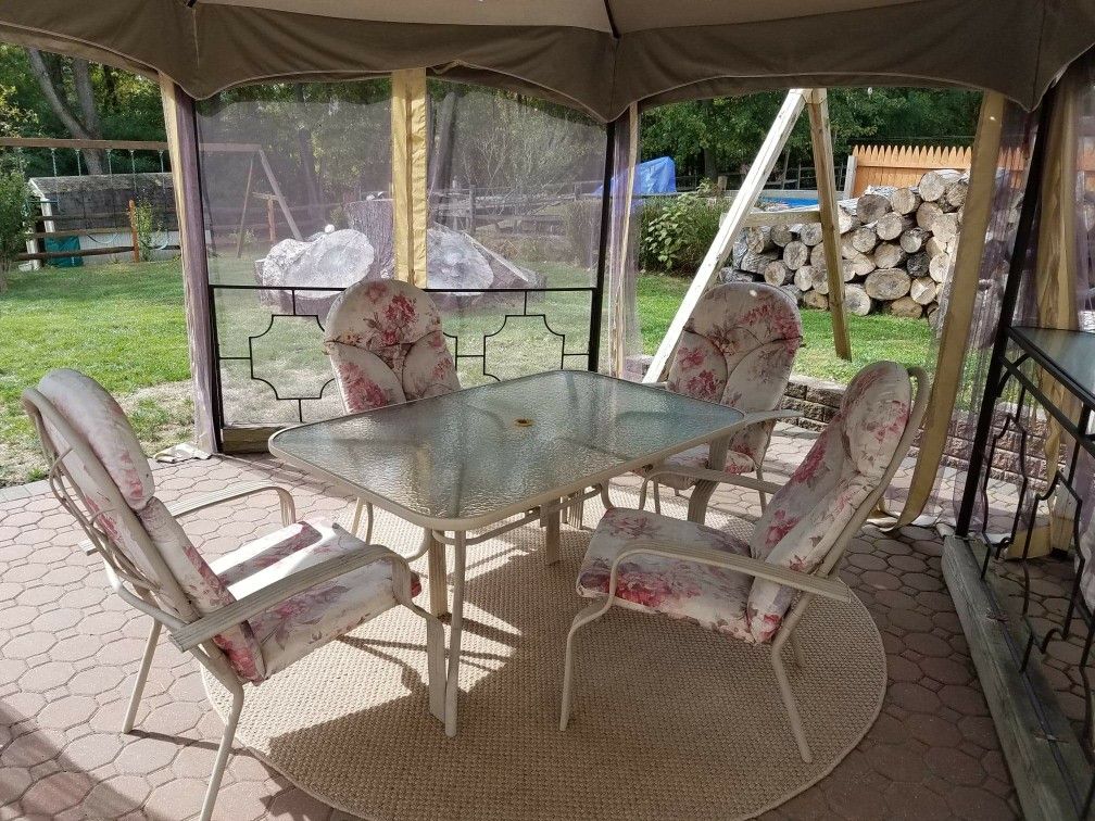 Patio glass table with 4 chairs & cushions, includes under table umbrella base holder ( umbrella not included)