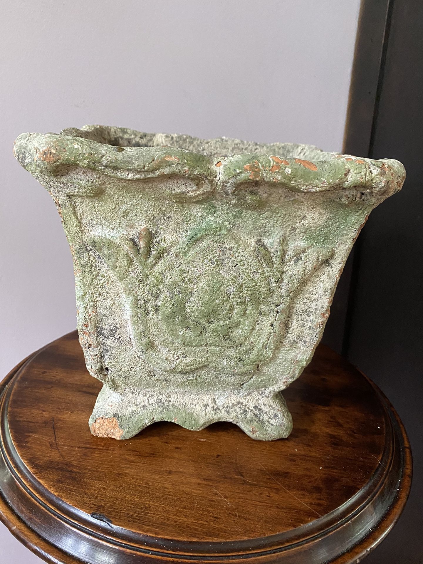 Vintage green terra cotta plant pot with water hole.