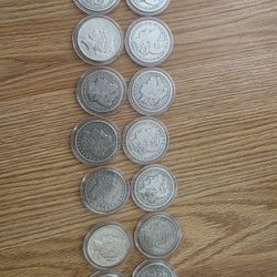 A Dozen MORGAN AND PEACE SILVER DOLLARS