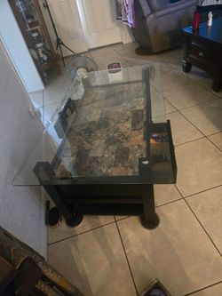 Coffee table. Glass top. drawers that open at both sides of the table