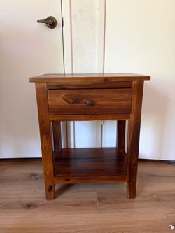 Dark wood nightstand.
