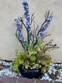 Decorative combined green flowers plant with purple faux flowers