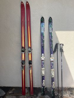 Pair of Elan GC skis with poles and pair of vintage wooden Slalom racer skis