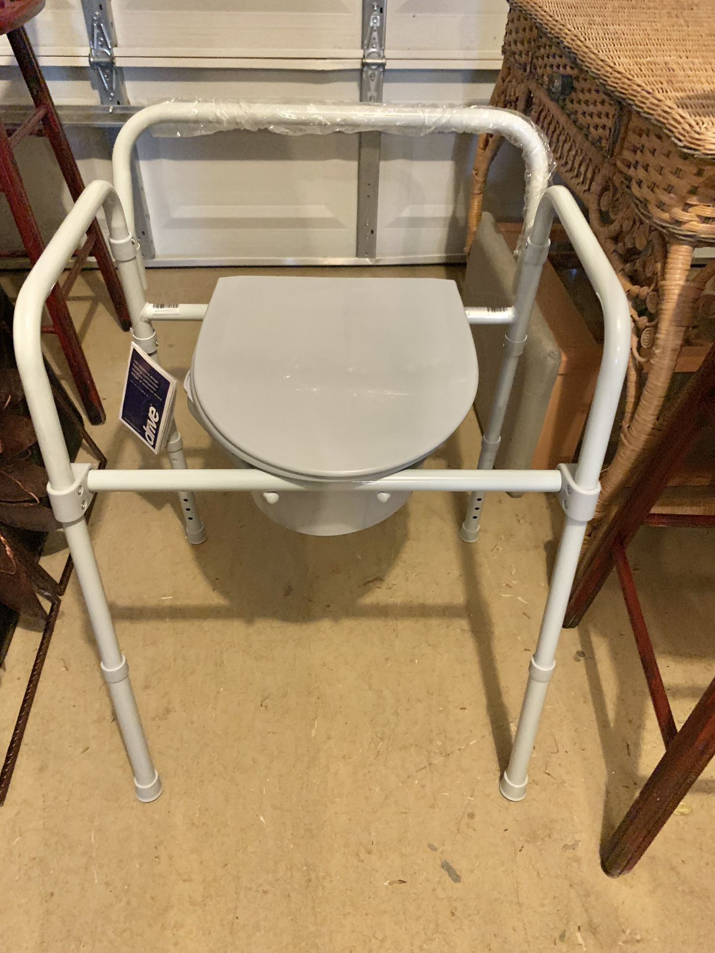 Brand new never used tag attached plastic attached All-In-One Steel Folding Commode Toliet 11148N-4 by Drive Medical 