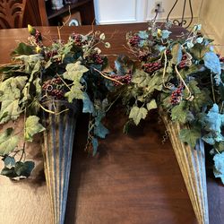 Decorative wall sconces with faux greenery