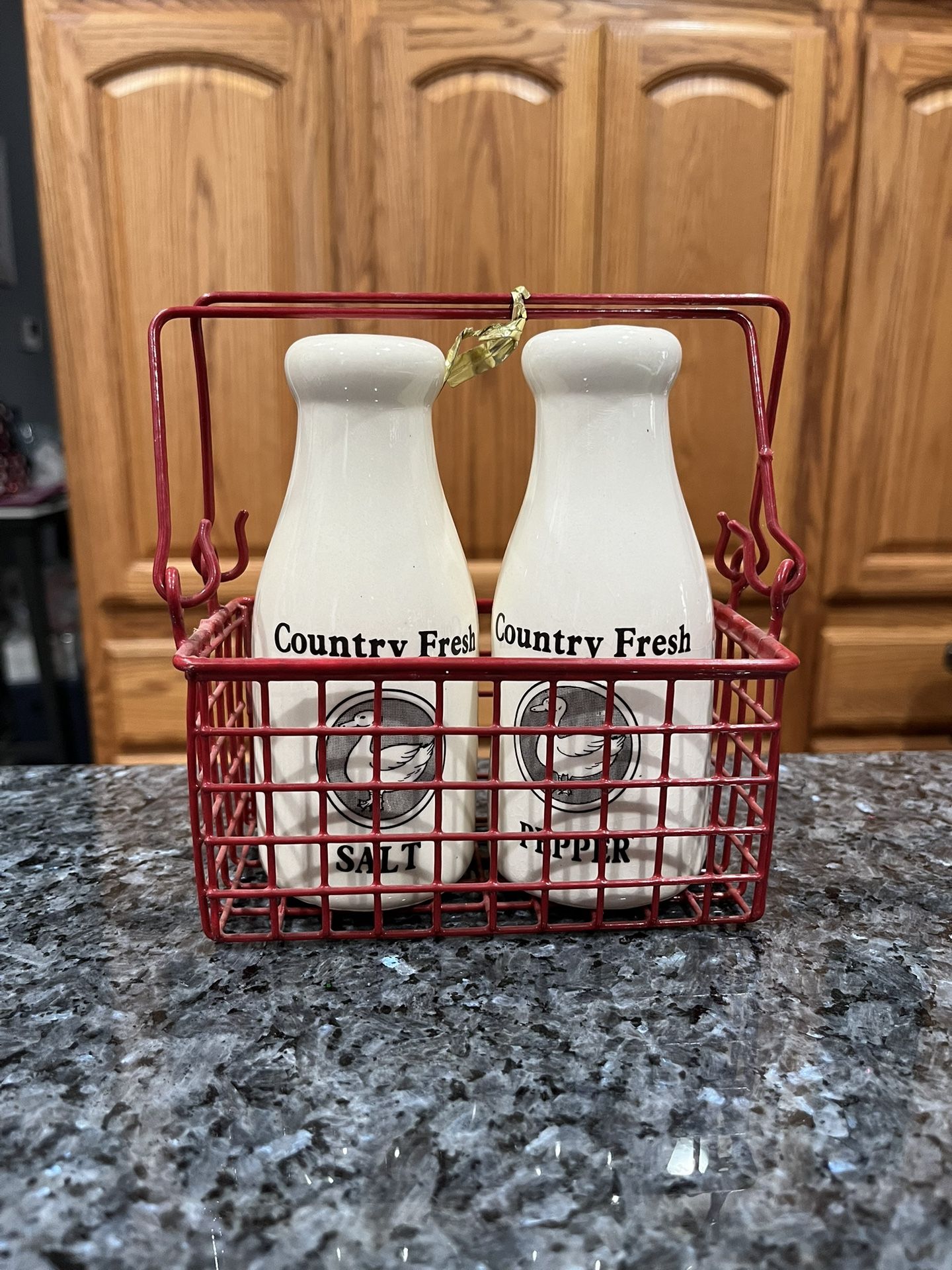 Vintage Milk Jug Pair of Salt and Pepper Shakers with Red Delivery Basket.  The shakers have “Country Fresh” written on them.  Size approximately 5 in